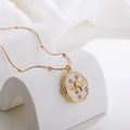 Macro view of vintage gold angel pendant necklace featuring shell inlay and zircon accents - Angel Wing