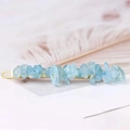 Detailed macro shot of light blue natural crystal stones on a golden metal hair pin - Aquamarine + Gold Clip