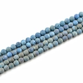Macro detail of 10mm frosted blue natural stone beads with iridescent metallic luster - Sky Blue
