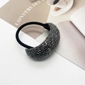 Black elastic hair tie with sparkling rhinestone semi-circle decoration in a lifestyle setting - Bent Corner Gun Black