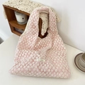 Close-up of intricate white daisy floral embroidery on a soft pink canvas tote bag - Vest Bag