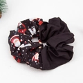 Detailed view of black velvet Christmas scrunchie with festive Santa Claus and gift patterns - Christmas Print 01# Black