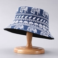 Close-up of navy blue bucket hat with white elephant patterns on a wooden stand - One Size / Blue Elephant