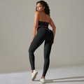 Detail view of black ribbed yoga set showing seamless high waist leggings and sports bra - Black