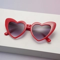Sparkly red heart shaped sunglasses with purple gradient lenses on a white display stand - Red Frame Double Gray Lens