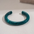 Macro shot of dark green acrylic open C-shaped bracelet with marble texture and round edges - Narrow Green Marble (HB4782)