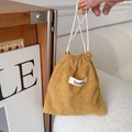 Mustard yellow corduroy drawstring pouch with brand label and white rope handles - Turmeric
