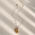 Golden starfish and scallop pendant necklace with pearls on a summer shadow background - Gold
