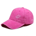 Detailed macro view of the rose red washed cotton fabric and white sun embroidery on the cap - One Size / Rose Red