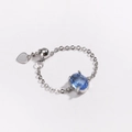 Macro shot of silver chain ring with oval blue zircon and heart-shaped metal pendant - Blue Zirconia-Platinum