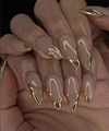 Macro shot of nude almond nails with elegant metallic gold French tips and glossy finish - BZ1469 Nude Gold Edge / Glue Type