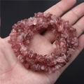 Natural strawberry crystal stone beads held in hand for DIY jewelry making accessories - 5-8mm Irregular Chips
