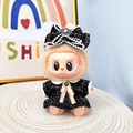 Labubu doll in black tweed jacket with pearl bow accessory on a woven mat - Retro Chanel-style Black Dress / First And Second Generation Keychains Are Compatible With La Cloth Dolls. Dolls Not Included.