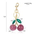 Detail view of pink cherry keychain with green leaves and golden hardware size specs - Pink Purple/Gold Buckle