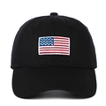 Black cotton baseball cap with embroidered American flag patch on a white background - Black
