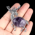 Silver alloy elk brooch pendant featuring a large oval purple amethyst crystal stone - Amethyst
