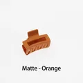 Close-up of matte orange square claw clip showing spring mechanism and frosted texture - Matte Orange