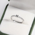 Macro shot of silver letter H ring with crystal inlay in green velvet jewelry box - Platinum H