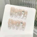 Luxurious cat eye press-on nails with 3D crystals and heart pendants on display - XS / Long Almond Shape