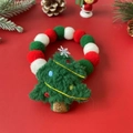 Macro shot of festive red, green and white Christmas pom-pom collar for dogs and cats - Christmas Tree Decoration Collar