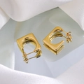 Macro shot of 18K gold plated C-shaped geometric hoop earrings on silk with mirror reflection - Gold Geometric Square Hoop