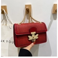 Fashionable dark red snakeskin leather crossbody bag with golden bee buckle and chain strap - Red