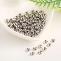Macro view of polished 18K gold-plated spacer beads in a heart-shaped ceramic bowl - 6mm Hole 2.0mm / White Gold