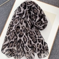 Classic leopard print bali yarn scarf with brown and black animal pattern on white board - Khaki