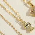 Detailed macro view of the golden bear pendant with sparkling white zircon stones - Black Eyed Bear