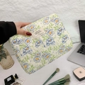 Beige quilted makeup bag with blue floral pattern and handle held by hand - Green Ribbon Flower Medium (25x18x7)