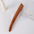 Detailed view of a brown plush animal tail accessory with an elastic strap for cosplay - Dark Coffee Tail