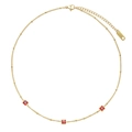 Detail view of the gold stainless steel necklace featuring three square red crystals - Gold Triple Square Red Gemstone