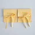 Elegant yellow microfiber jewelry pouch with a matching ribbon bow and Vinknde logo - Yellow