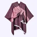 Detail view of the thick knit fabric texture and white fringe tassels on the poncho - Horizontal Stripe with White Fringe and Slash / Burgundy