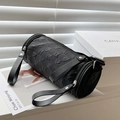 Minimalist black cylinder shoulder bag with crinkled texture and silver rivet details - Black