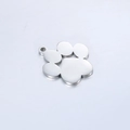 Close-up of a silver mirror-polished stainless steel paw print charm with a hanging hole - Steel