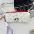 Detail of heart quilted pencil case featuring puppy embroidery and a purple lanyard - Headphone Dog