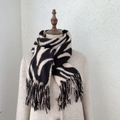 Detail of soft zebra striped knitted scarf with elegant fringe trim for winter warmth - 185*65cm / Off White