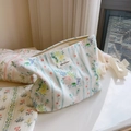 Macro view of blue floral cotton makeup bag featuring a Simple Wish woven label - Light Blue Striped Floral