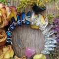 Macro detail of blue crystal columns and silver moon pendant on a Wicca crown headband - Dark Blue & White Mix + White K Moon