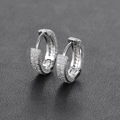 Macro detail of silver hoop earrings with full pave micro-set white zircon stones - Silver