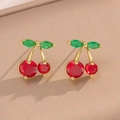 Elegant gold cherry stud earrings with red and green gemstones on beige fabric - Cherry Stud Earrings (441)