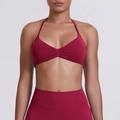 Close-up of seamless dark red halter neck sports bra with ruched detail and high-waist leggings - Burgundy