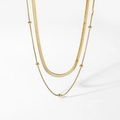 Double-layered gold flat snake chain necklace with round bead accents on white background - Gold
