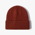 Classic rust red cuffed beanie hat featuring vertical ribbed knit texture for winter - One Size / Rust red