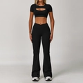 Black two-piece workout set with cutout crop top and cross-waist flared yoga pants - S / Top And Bottom / Short Sleeve + Flare Pants / Premium Black
