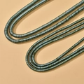 Macro shot of 4mm metallic hematite disc beads with teal luster for DIY jewelry - Approx. 350 pcs per strand / 6# Green Disc (4*1mm)