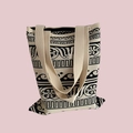 Close-up of beige woven canvas tote bag with black vintage geometric pattern on pink background - Beige Black Retro