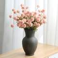Pale pink artificial dandelion globe flowers in a vintage dark textured ceramic vase - Light Pink