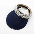 Close-up of navy straw sun hat featuring elegant white pearl embellishments on the headband - Navy Blue